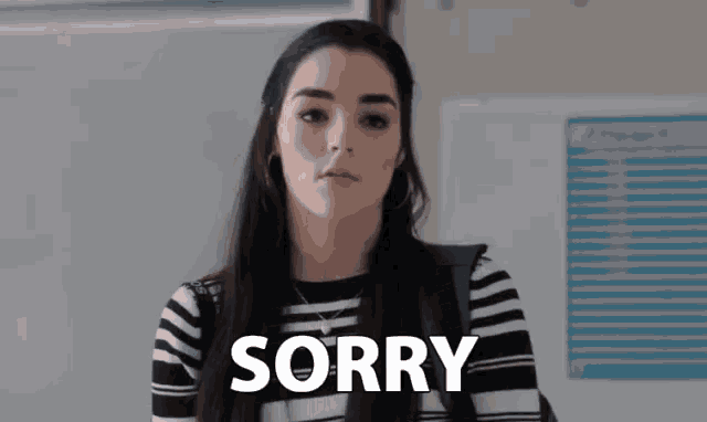 a woman with a backpack says sorry in front of her