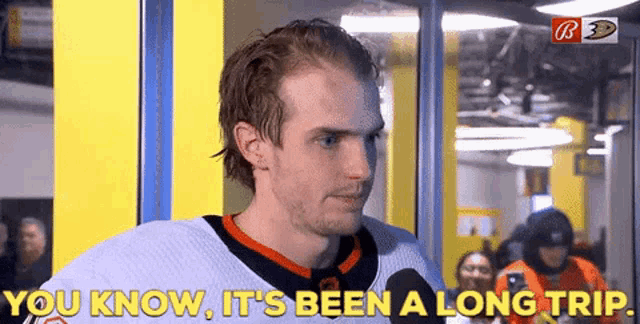 a hockey player is talking into a microphone and says you know it 's been a long trip