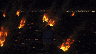 a man standing on top of a building looking at fires