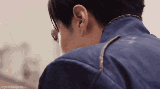 a close up of a man 's ear with the words dryedmangoez.com below