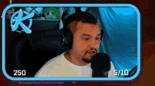 a man wearing headphones is talking into a microphone while playing a video game .