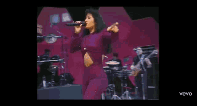 a man and a woman are singing into microphones on a stage .