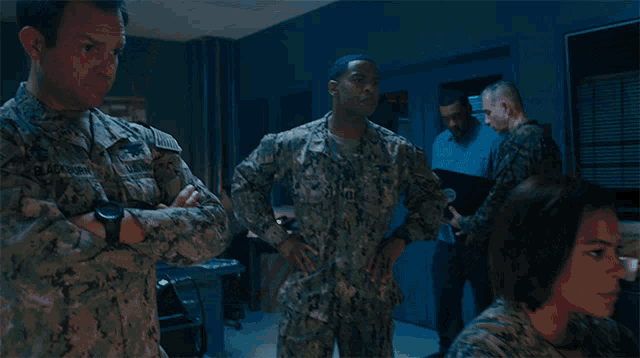 a man in a military uniform is standing next to another man with the words it better below him