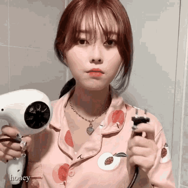 a woman holding a hair dryer and a comb with the word honey below her
