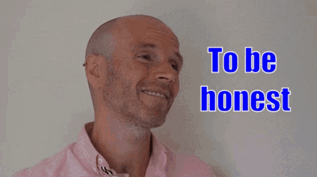 a bald man in a pink shirt with the words you 're coming across above him