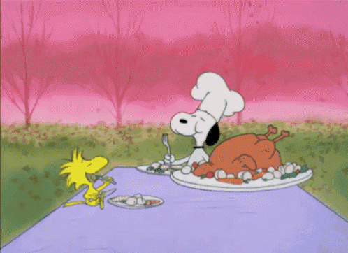 a cartoon of snoopy and woodstock sitting at a table eating a turkey