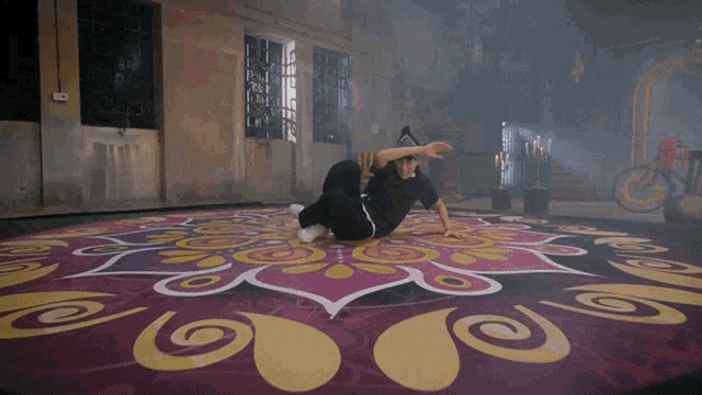 a man is doing a trick on a colorful carpet
