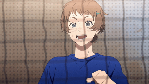 a girl in a blue shirt is smiling in front of a wall with holes in it