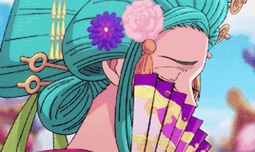 a woman with a flower in her hair is holding a fan in front of her face .