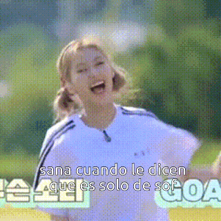 a girl in a soccer uniform is laughing with the words sana cuando le dicen que es solo de sof goal behind her
