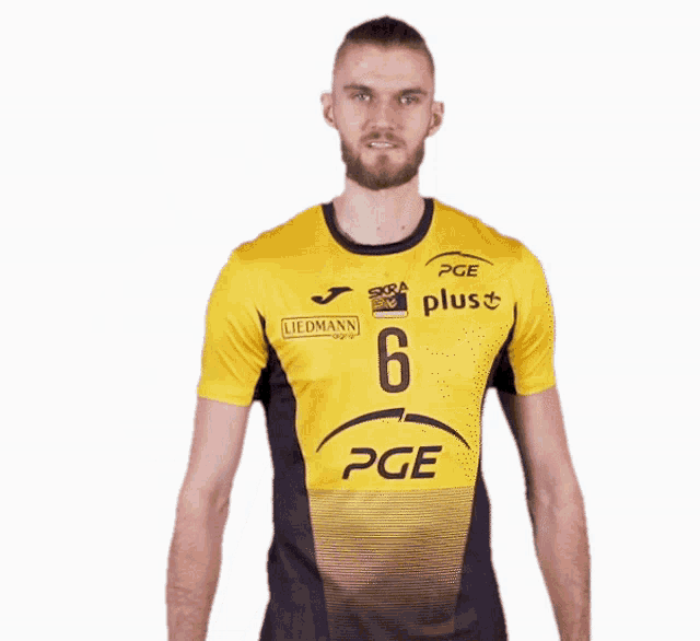 a man wearing a yellow and black pge jersey