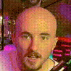 a bald man with a beard and mustache is looking at the camera