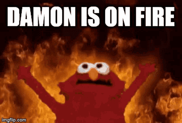 elmo is standing in front of a fire with the words damon is on fire below him