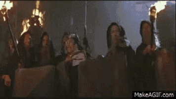 a group of people holding guns in front of a fire