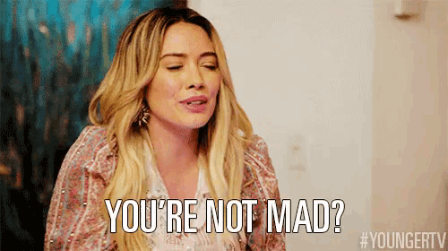 a woman is making a funny face and says `` you 're not mad '' .