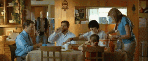 a group of people are sitting around a table with a box that says crunchy on it