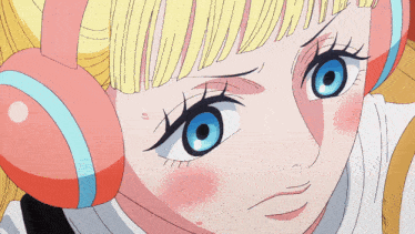 a close up of a girl 's face with a surprised look on her face