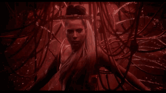 a woman in a red dress is surrounded by red lines