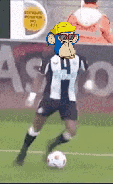 a monkey wearing sunglasses and a yellow hat kicks a soccer ball on a field