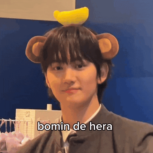 a young man wearing a monkey hat with a banana on top of it