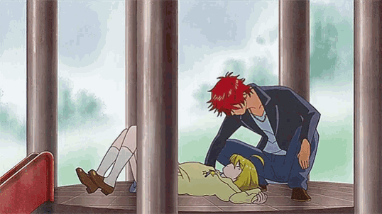 a man with red hair is kissing a girl on the forehead