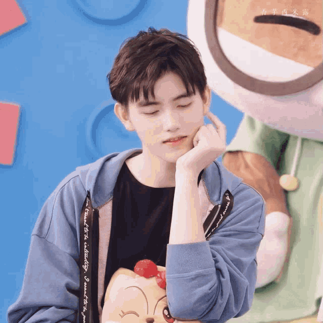 a young man wearing a blue hoodie with the word snoopy on the sleeve