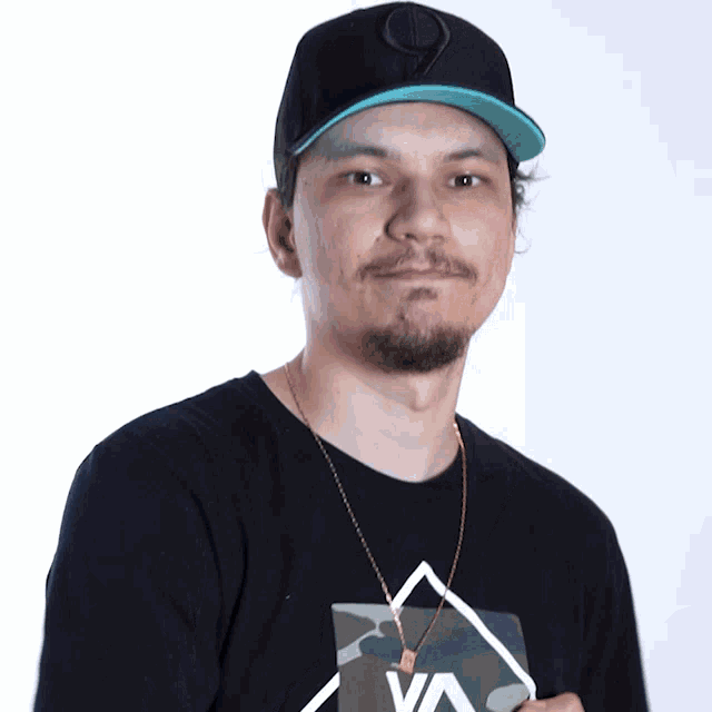a man wearing a black shirt with a camo triangle on it