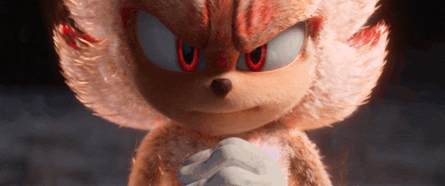 a close up of a stuffed animal with red eyes and white fur