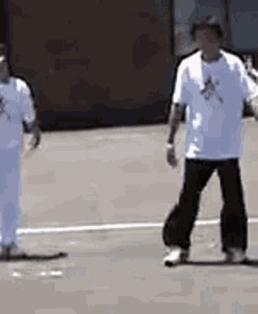 two men are walking down a street .