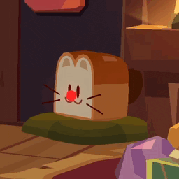 a piece of bread that looks like a cat has a red nose