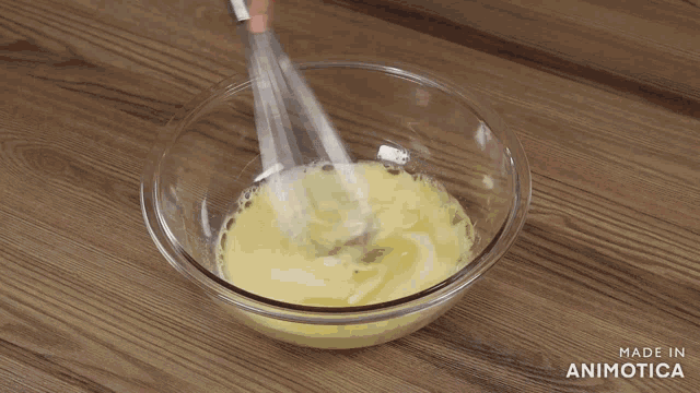 two and a half cups of flour is being poured into a bowl of liquid