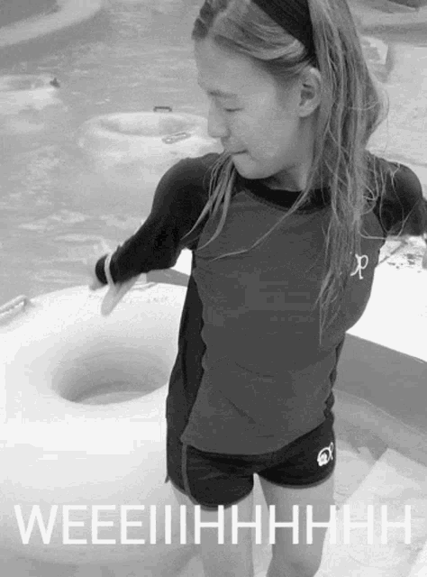 a black and white photo of a girl with the words weeeiihhhh written on the bottom