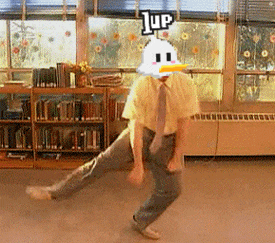 a man in a yellow shirt and tie is dancing in front of a window with a sign that says 1up