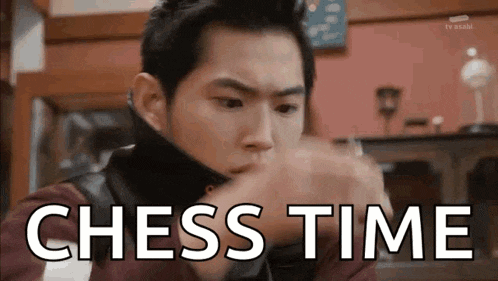 a man is playing chess and the words `` chess time '' are written on the screen behind him .