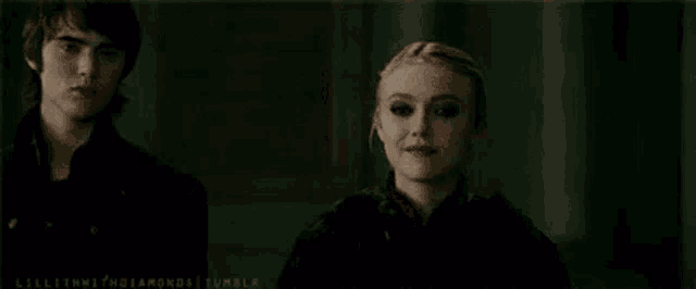 a man and a woman are standing next to each other and the woman is saying pain .