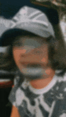 a blurry picture of a person wearing a hat and a shirt that says ny