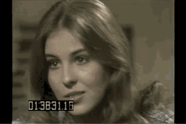 a close up of a woman 's face with the time 01:38:31.16 displayed