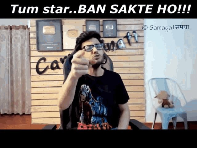 a man wearing glasses is pointing at the camera with the words tum star ban sakte ho