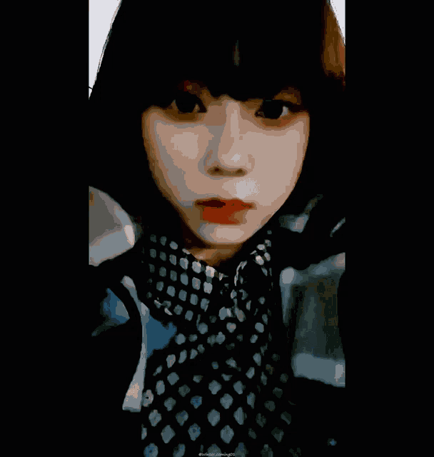 a close up of a woman 's face with a black background