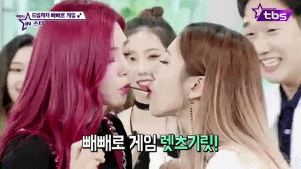 a group of women with red hair are kissing each other on the cheek .