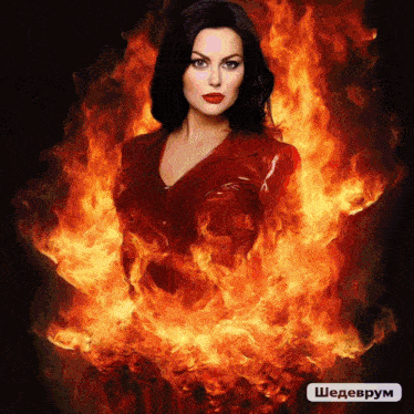 a woman in a red leather jacket is surrounded by flames and a sign that says shedevrum