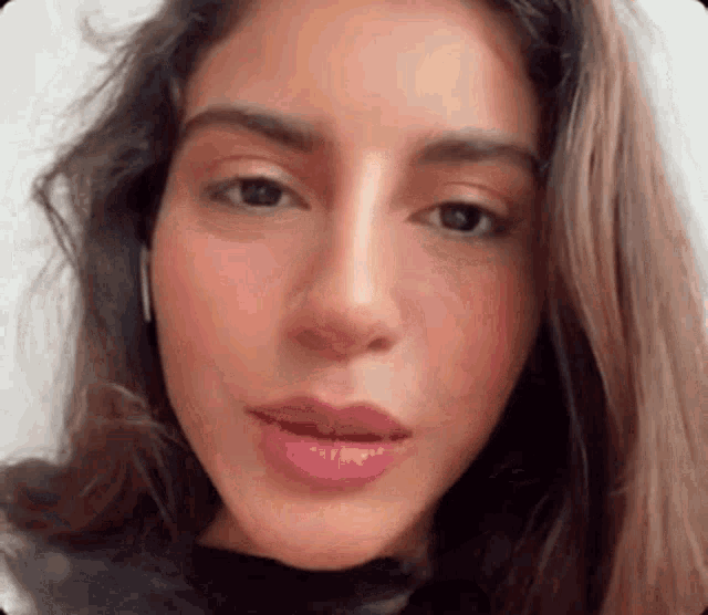 a close up of a woman 's face with headphones on