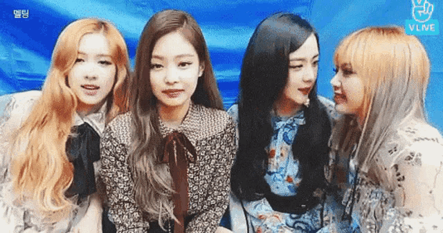 a group of girls are standing next to each other and looking at each other