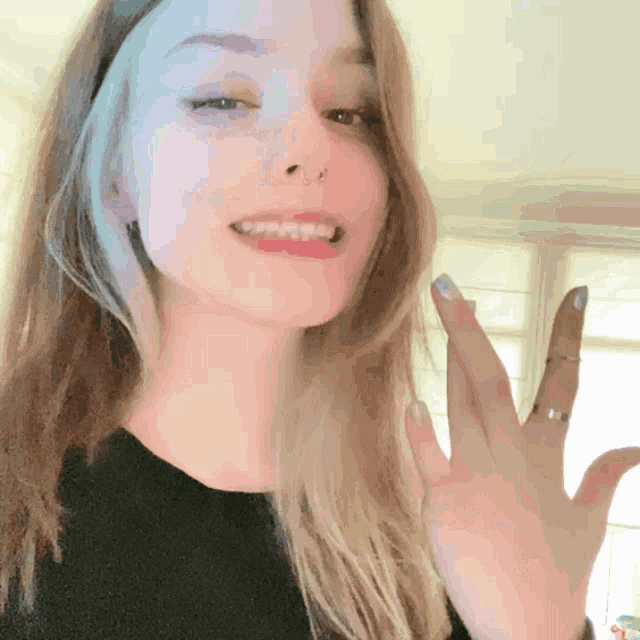 a girl with a nose ring and a ring on her finger