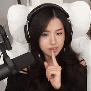 a woman wearing headphones and a microphone is sitting in a chair .