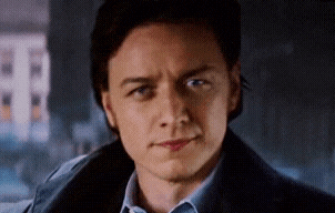 a close up of a man 's face with a blue shirt and a blue jacket .