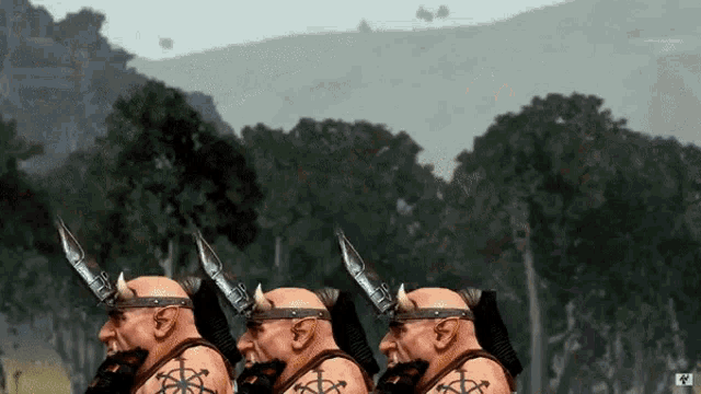 three dwarfs with horns on their heads are standing next to each other in front of trees