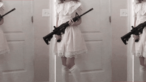 a woman in a white dress holds a gun