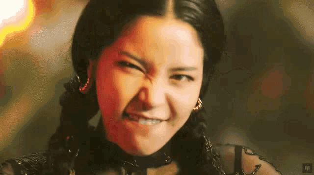 a close up of a woman making a funny face with the letters np below her