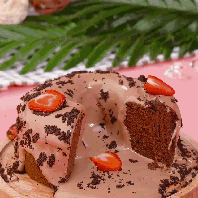 a chocolate bundt cake with strawberries and oreos on top